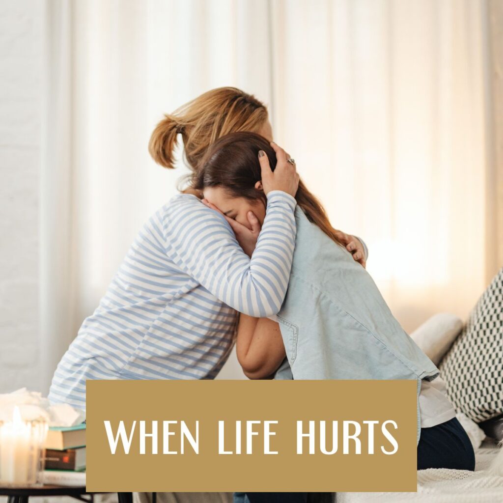 two crying women embracing