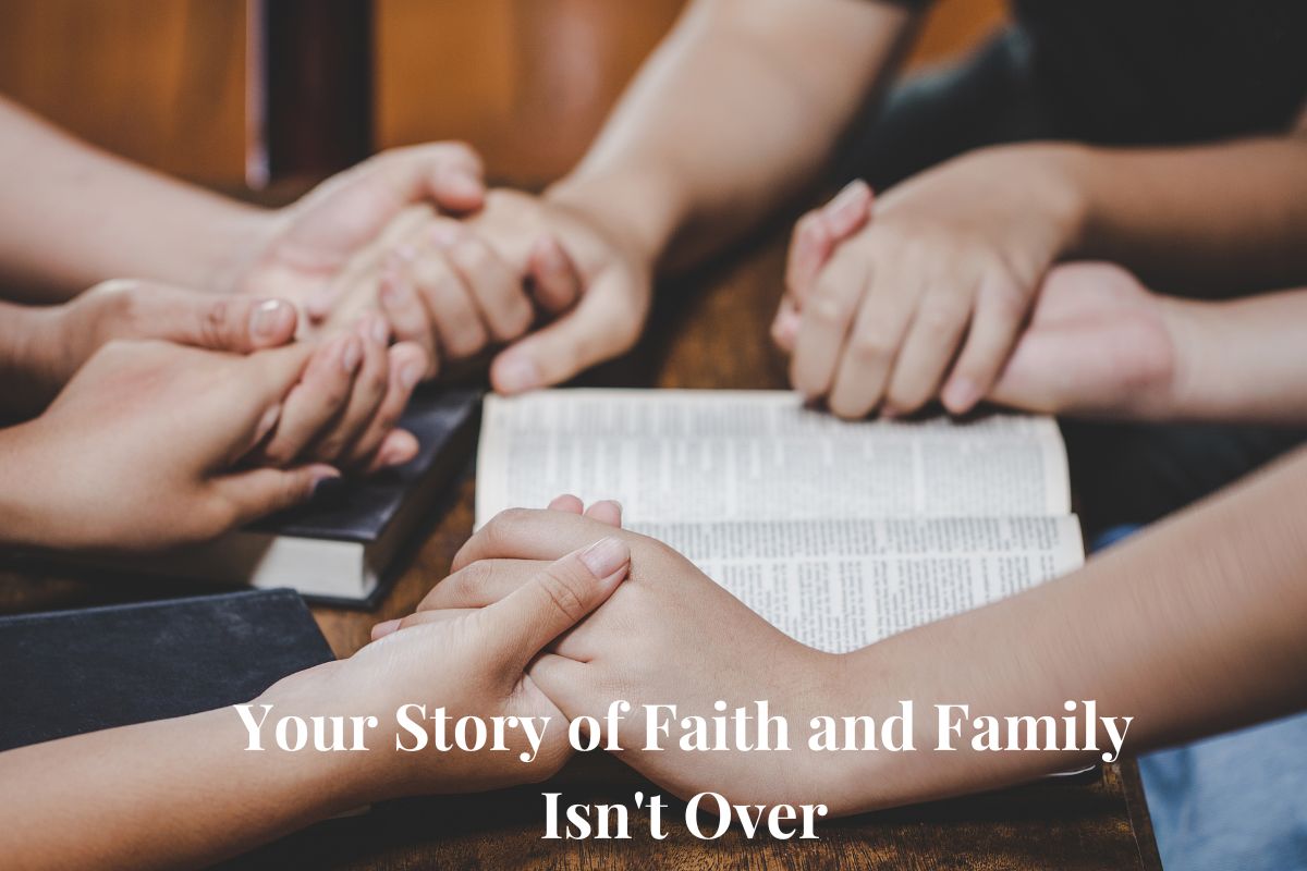 moving forward in faith showing family's hands clasped in prayer