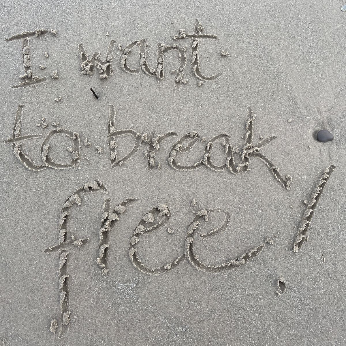 I want to break free drawn in the sand