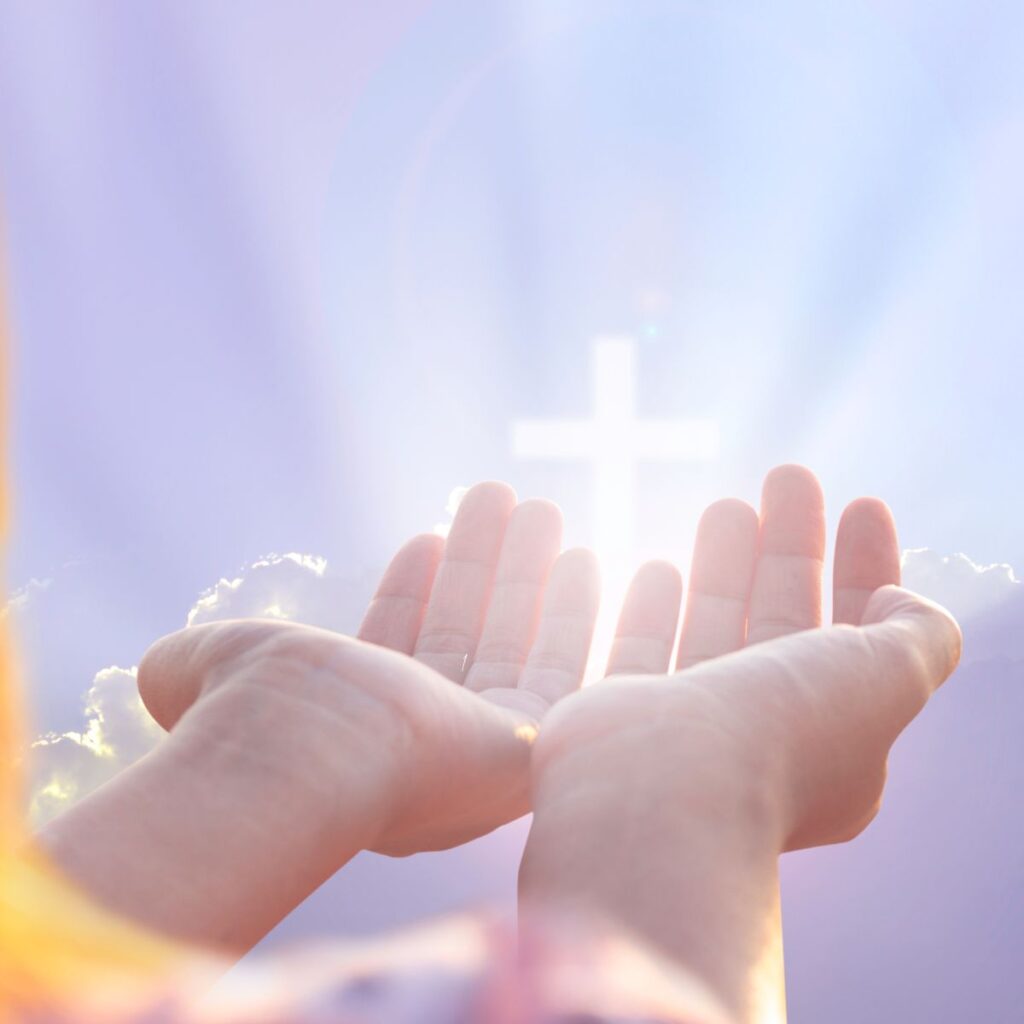 child's outstretched hands with family sharing baby dedication
