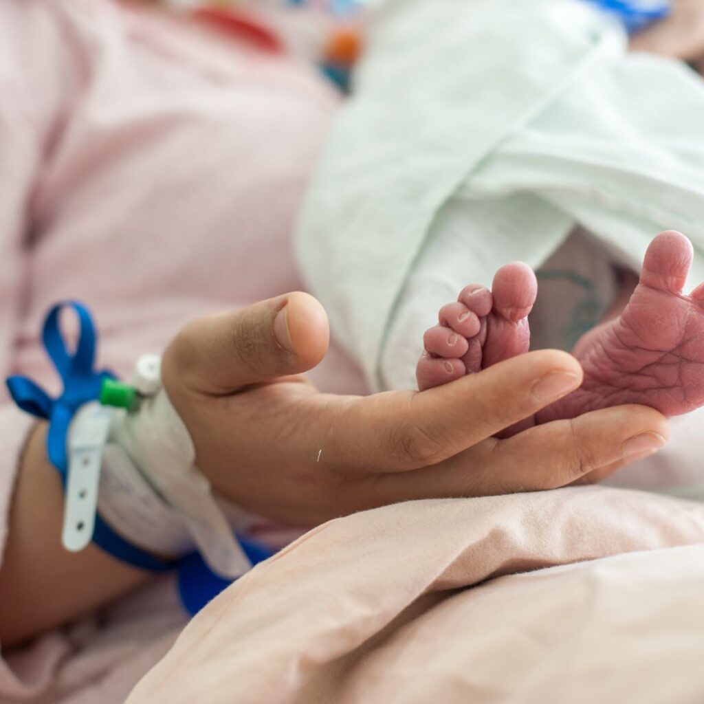 mom holding baby's feet assuring God's timing